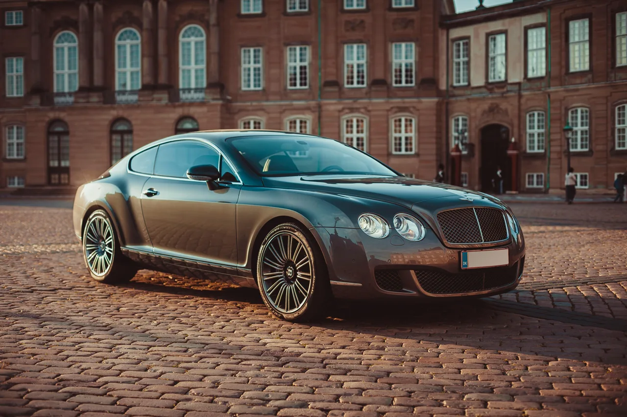 Dark Bentley coupe on a cobblestone street