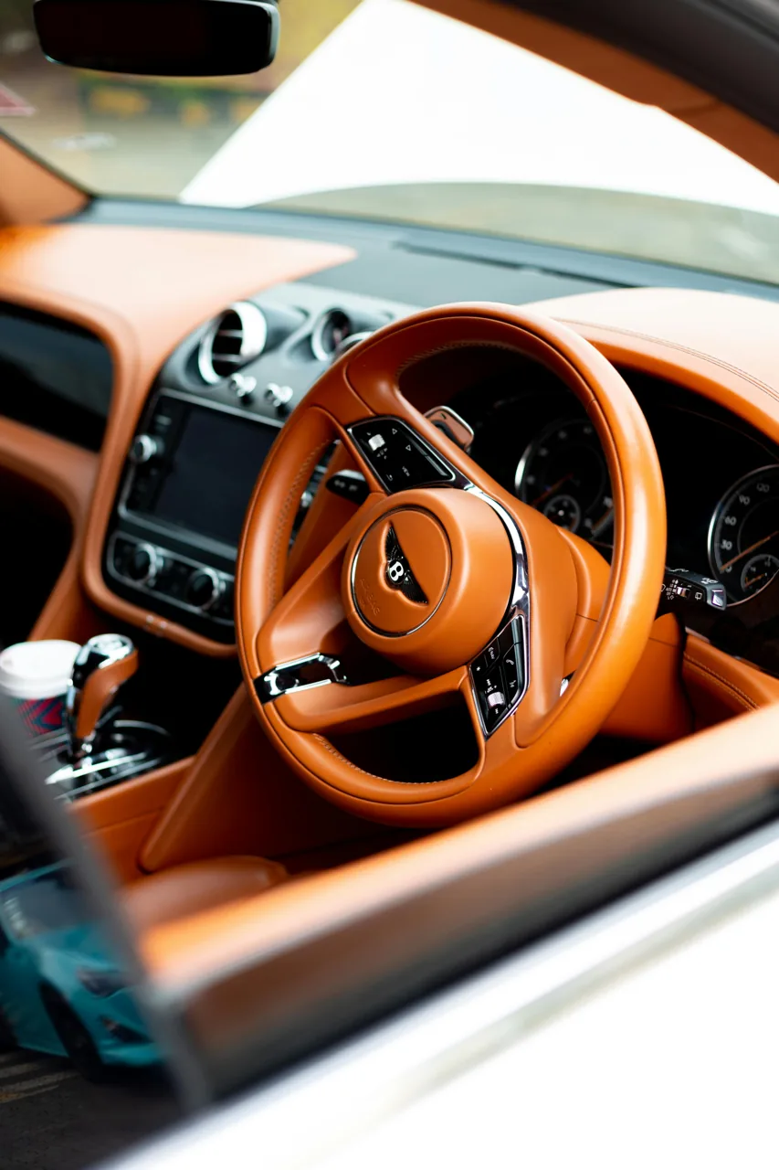 Tan leather dashboard and steering wheel in a Bentley