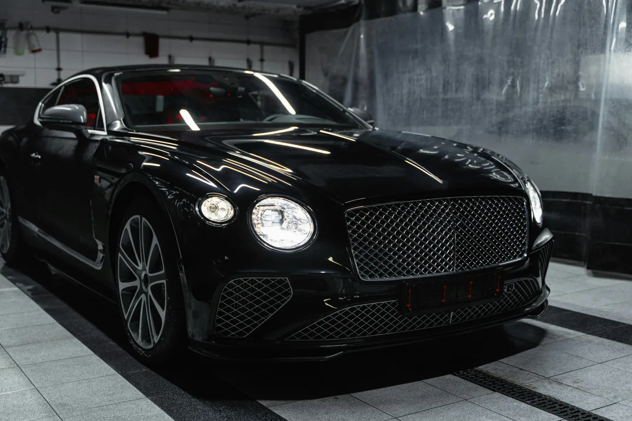 Black Bentley coupe parked in an indoor garage