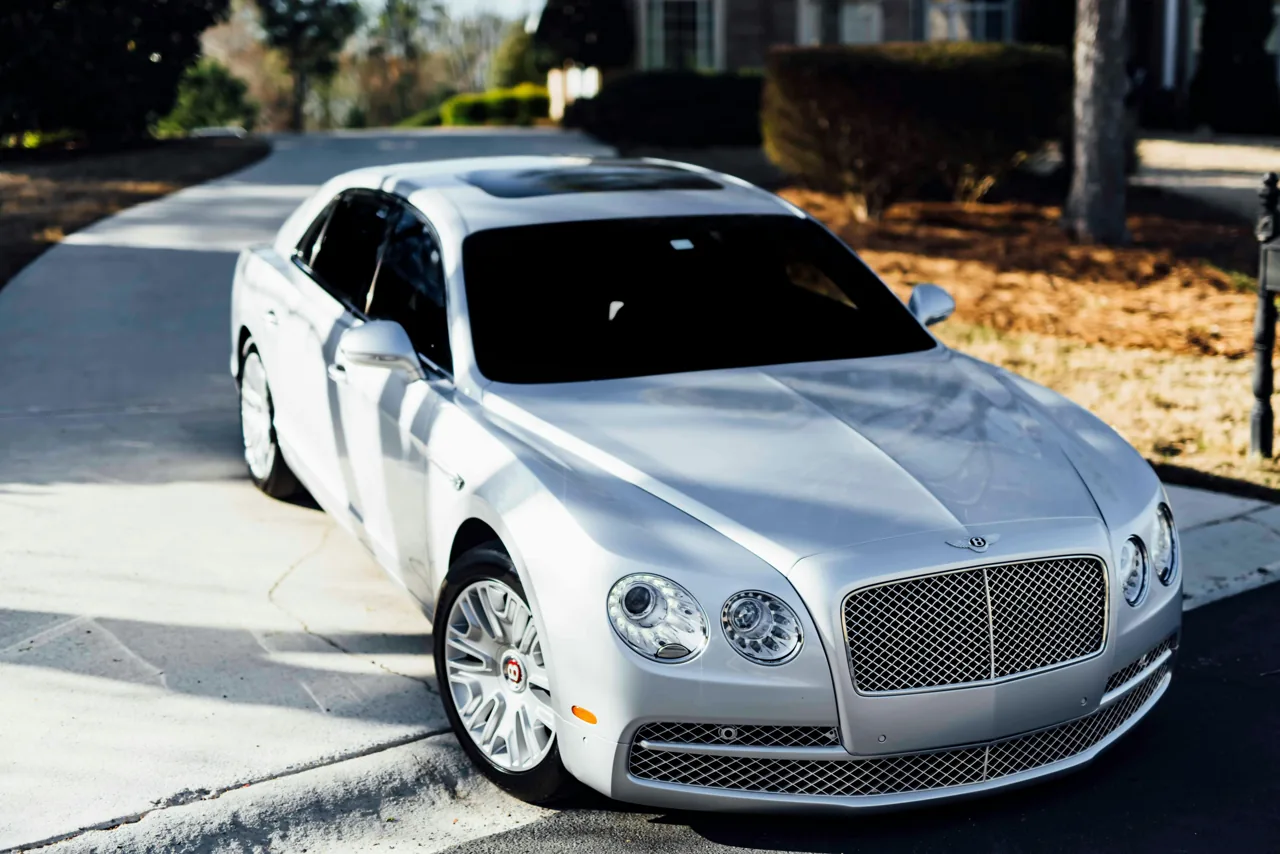Silver Bentley coupe on a driveway